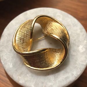 Gold infinity ribbon brooch